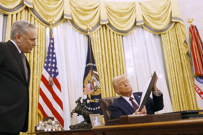David Sacks, the White House 'czar' for artificial intelligence policy, speaks to President Trump as he signs a series of executive orders in the Oval Office on Jan. 23, 2025.