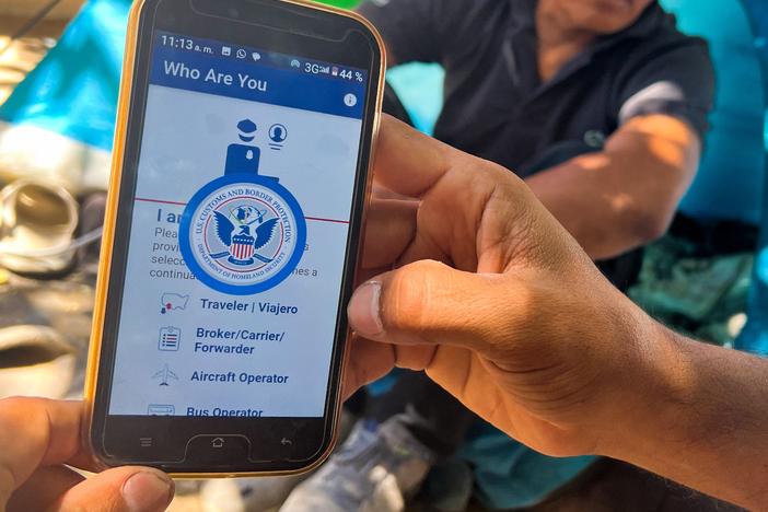 A migrant at the U.S.-Mexico border shows the CBP One App from the U.S. Customs and Border Protection agency that is used to apply for an appointment to apply for asylum.