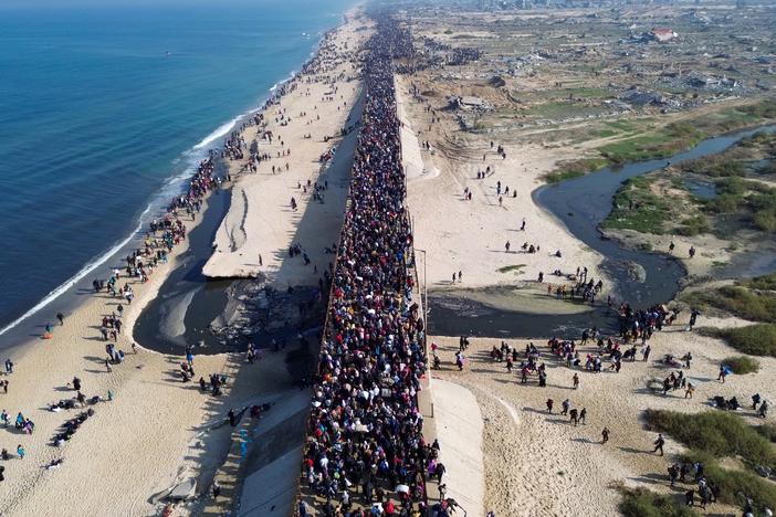 This aerial photo shows displaced Gazans walking toward Gaza City on Jan. 27, 2025, after crossing the Netzarim corridor from the southern Gaza Strip.