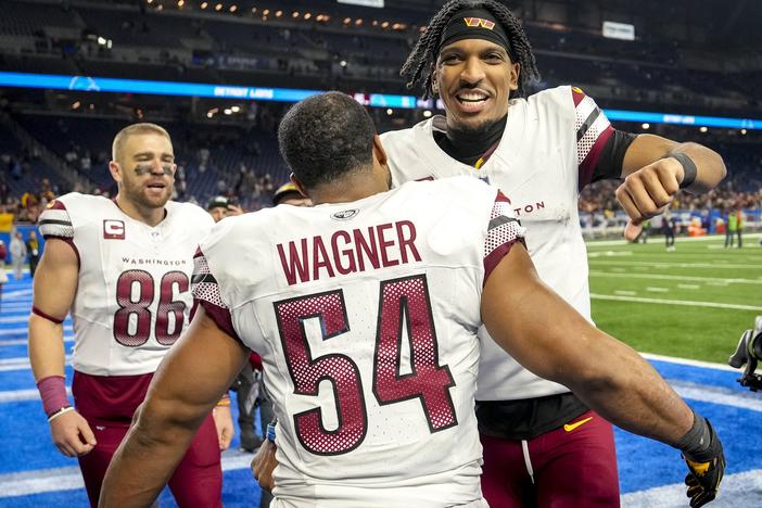 Jayden Daniels celebrates with Washington Commanders teammates Zach Ertz and Bobby Wagner after defeating the Detroit Lions in the NFC Divisional Playoff on Jan. 18, 2025 in Detroit.