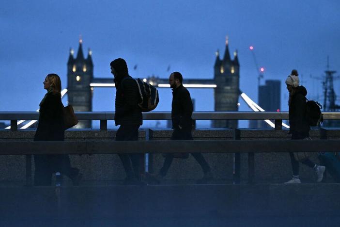 Commuters cross London Bridge. Maybe some of them have a four-day workweek.