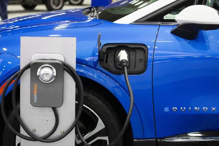 A Powering Michigan display about electric vehicles and charging is shown at the 2025 Detroit Auto Show on Jan. 10. The Biden administration promoted electric vehicles through a range of policies, which the Trump administration is in the process of reversing.