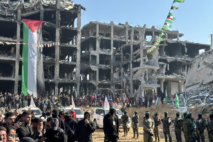 Vehicles with the International Committee of the Red Cross arrive, while Palestinian militants and civilians stand by, for the release of Israeli hostage Agam Berger in Jabalia, Gaza Strip, Thursday.