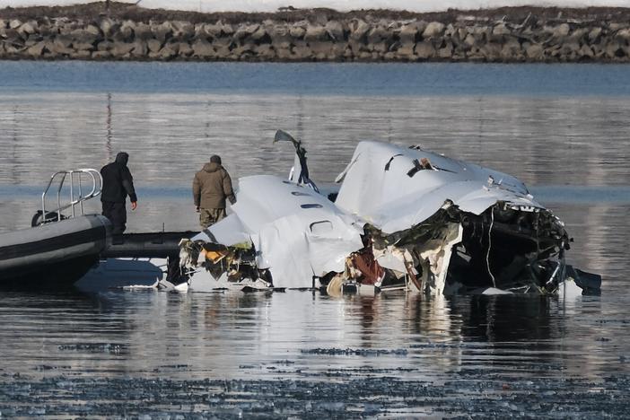 First responders search the crash site of American Airlines Flight 5342 along the Potomac River near Ronald Reagan National Airport in Arlington, Va., on Thursday.