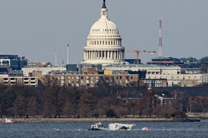 Emergency response units work at the site of the American Airlines plane that crashed into the Potomac River on Wednesday on approach to Reagan National Airport.