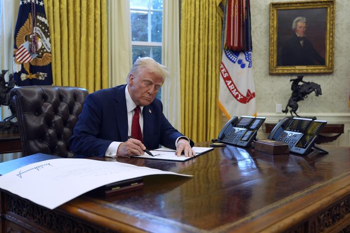 President Trump signs executive orders in the Oval Office at the White House,  Jan. 30.