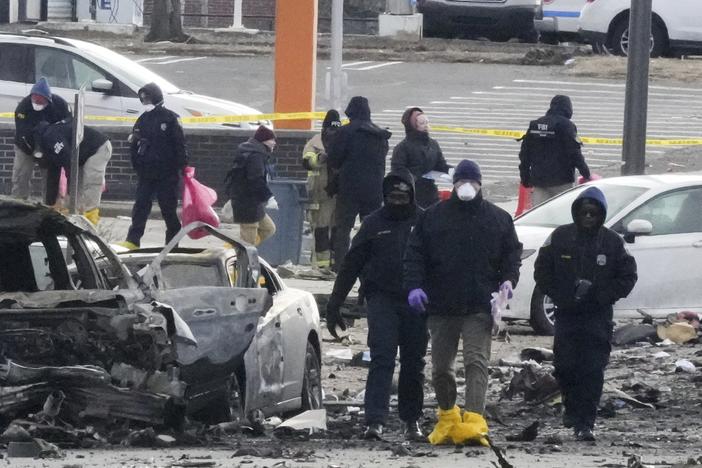 Investigators work the scene after a small plane crashed in Philadelphia on Saturday.