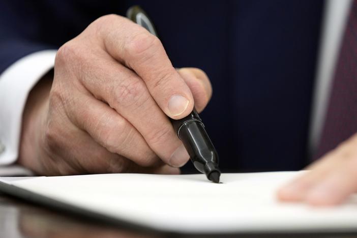 President Trump signs an executive order in the Oval Office of the White House last week.