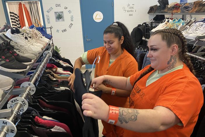 Blanca Hernandez (right) helps Jessica Lemos pick out clothes at the Elmwood Correctional Facility's Goodwill store on Jan. 9, 2025. Both are employees at the store, which allows exiting inmates to choose two outfits.