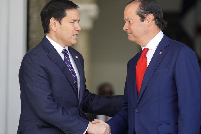Panama's Foreign Minister Javier Martinez-Acha (R) shakes hands with U.S. Secretary of State Marco Rubio while leaving a meeting at the presidential palace in Panama City, Panama, on Sunday.