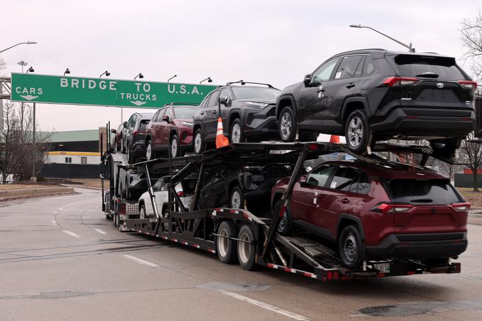A car hauler carries Toyota RAV4 vehicles as it enters to cross the Ambassador Bridge in Windsor, Ontario to go to Detroit, Michigan on February 3.