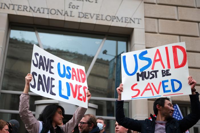 Protesters gather outside of USAID headquarters in Washington, D.C., on Monday, after Elon Musk said his Department of Government Efficiency will shut down the foreign assistance agency.