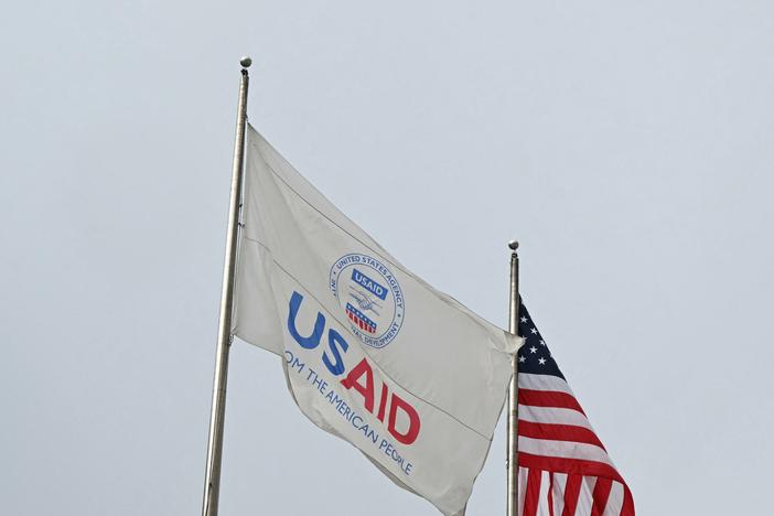 A USAID and American flag outside of United States Agency for International Development (USAID) headquarters in Washington, DC, on Feb. 3, 2025.