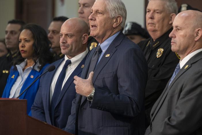 Nassau County Executive Bruce Blakeman, flanked by local police and federal officials, announces an agreement to "cross-designate" ten police detectives as ICE agents