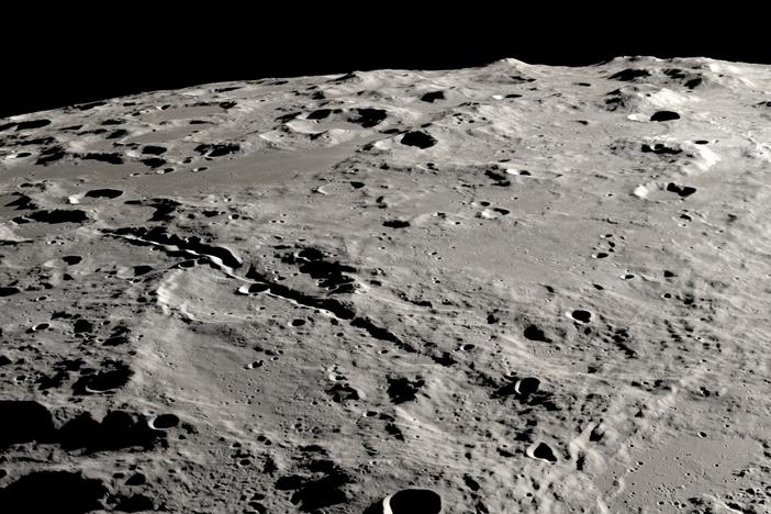 Two grand canyons on the moon radiating from the Schrödinger impact basin, from a view that looks obliquely across the lunar surface, like an astronaut in an approaching spacecraft.