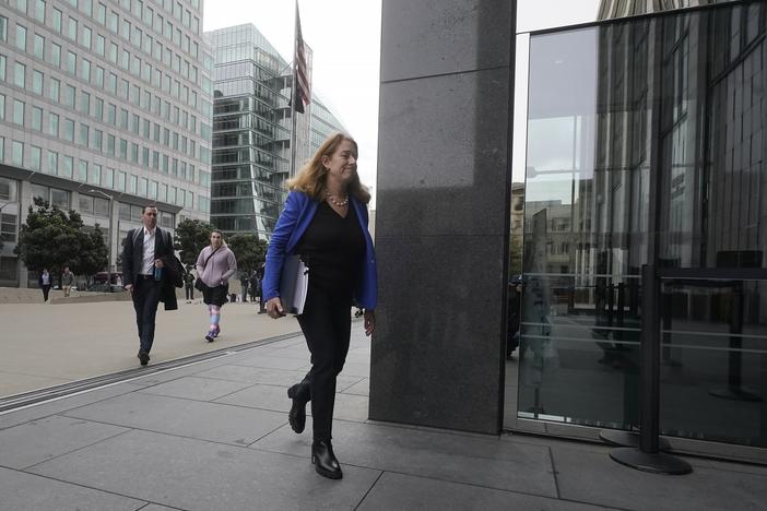 Attorney Shannon Liss-Riordan walks toward an entrance to a federal courthouse in San Francisco in December 2022. She is representing thousands of former Twitter employees suing the company over severance and other issues.