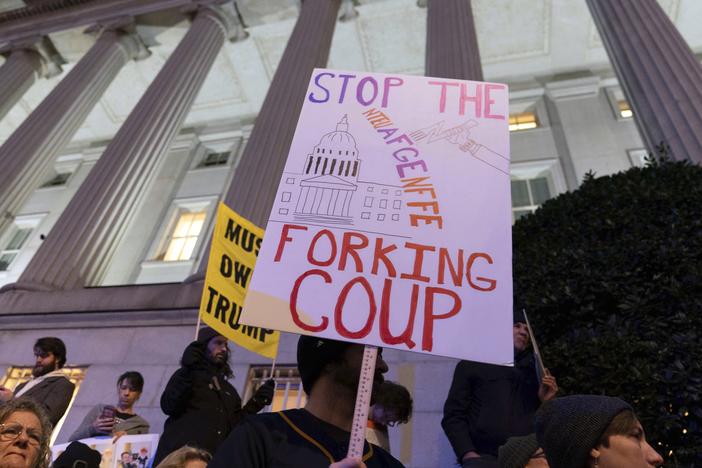 People protest during a rally against Elon Musk, seen as the architect of the "Fork in the Road" offer to federal employees, outside the Treasury Department in Washington, D.C., on Tuesday.