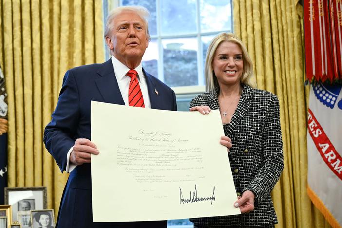 President Trump and Pam Bondi pose with the official commission signed by Trump that appoints Bondi to the position of U.S. Attorney General after she was sworn in in the Oval Office on Wednesday.
