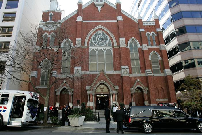 A hearse carrying the casket of Rosa Parks and a 1950s era bus sit in front of the Metropolitan AME Church where a memorial service for the civil rights icon was being held on Oct. 31, 2005, in Washington, D.C. A judge has ordered the naming rights of the extremist group the Proud Boys be given to the church.