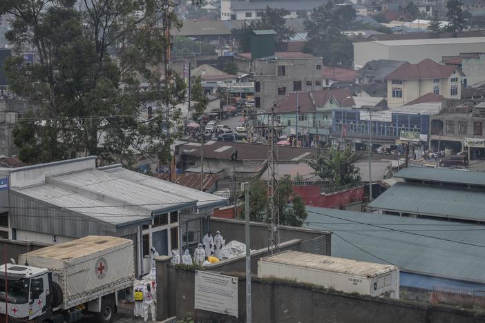 Red Cross personnel load bodies of victims of the fighting between Congolese government forces and M23 rebels in a truck in Goma, Monday as the U.N. health agency said 900 died in the fight.