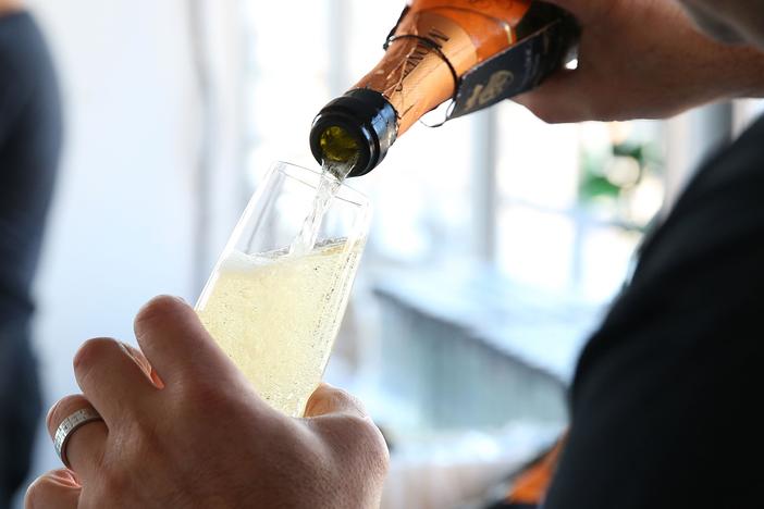 A bartender pours Prosecco at Founder's Welcome Breakfast during Food Network New York City Wine & Food Festival.