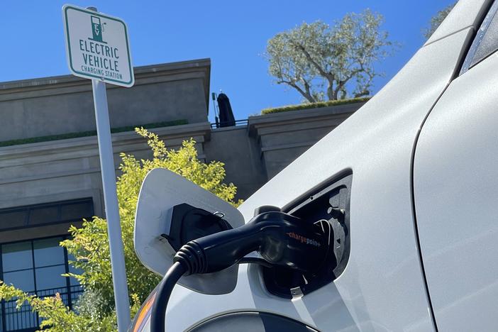 An electric car charges at a mall parking lot on June 27, 2022 in Corte Madera, California.