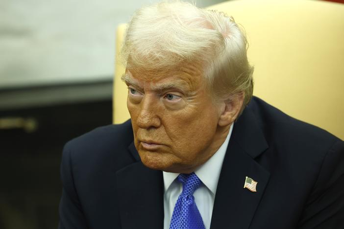 President Trump delivers remarks in the Oval Office on Friday. In a posting on his Truth Social site, Trump said he was revoking former President Joe Biden's security clearances.