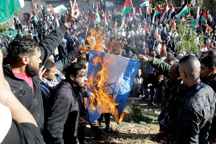Palestinian refugees burn an Israeli flag during a demonstration at the Jaramana Camp on the edge of Damascus, Syria, in 2017. At that time, they were protesting President Trump's decision to move the U.S. Embassy in Israel from Tel Aviv to Jerusalem. Today, they are opposed to Trump's call for Gaza residents to be relocated.