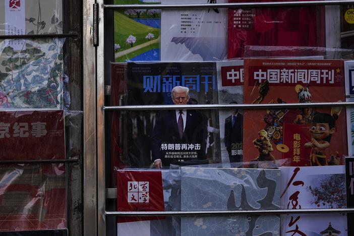 A magazine carrying a front cover of President Donald Trump with the words "Trump shock again" on display with other magazines at a bookstand in Beijing on Tuesday, Feb. 4.