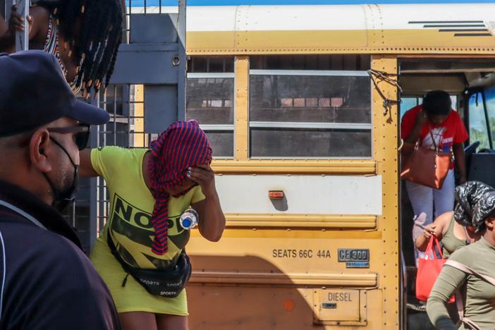 Haitians deported from the Dominican Republic get out of trucks in Carrizal, Dominican Republic, on the border with Haiti on Jan. 30.