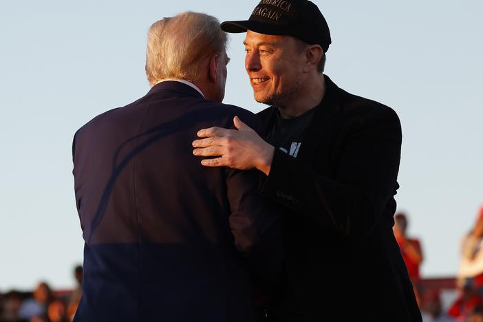 President-elect Donald Trump, left, and Elon Musk embrace at a rally in October 2024.