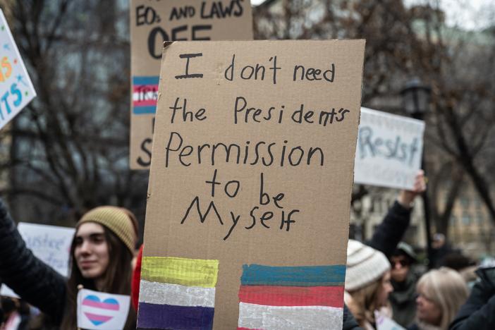 A homemade sign at a rally in Union Square in New York City on Saturday. Various hospitals across the country curbed gender-affirming care for people under 19 after President Trump's executive order.