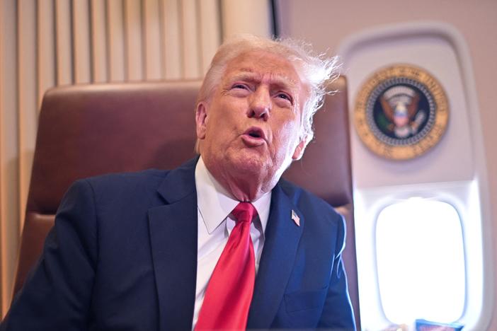 President Trump speaks to the press aboard Air Force One on Sunday.