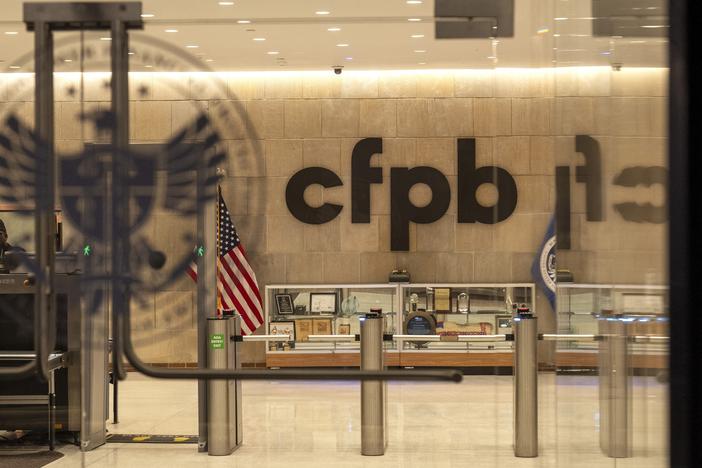 A security officer works inside of the Consumer Financial Protection Bureau (CFPB) building headquarters on Monday in Washington. Staff and contractors have been told the building is closed for the week, and to perform no work.