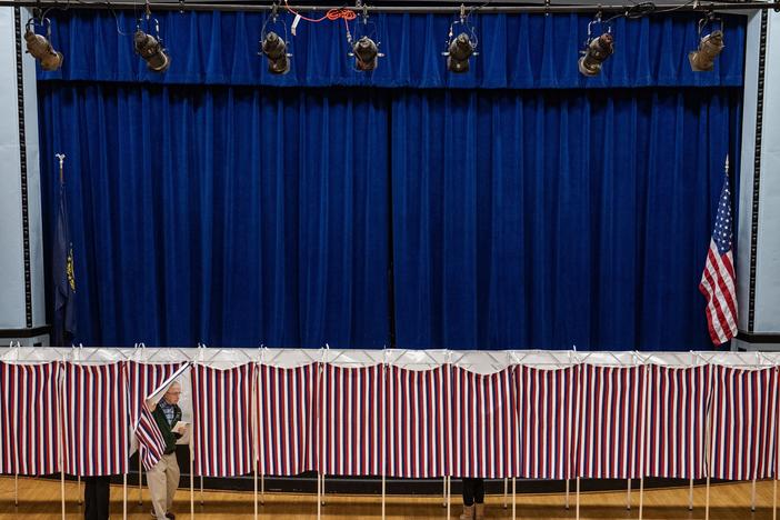 A man exits a voting booth at a polling station in Lancaster, N.H., on Election Day, Nov. 5.