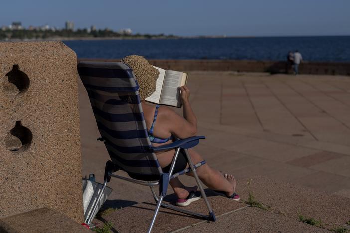 A woman sunbathes on a summer day in Montevideo, Uruguay, in January of 2025. This January was the hottest ever recorded on Earth.
