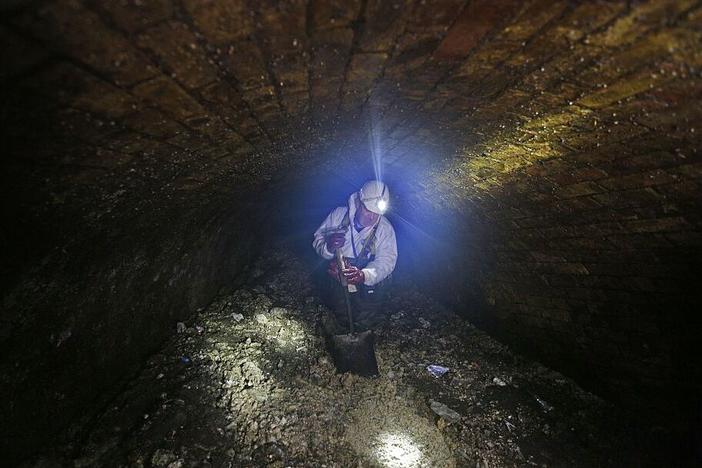 A London city worker clears up a fatberg in 2014. A fatberg in Australia caused the cancellation of a concert over the potential for wastewater overflow.