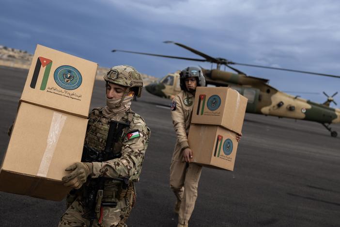 The Royal Jordanian Air Force's 8th Squadron unloads humanitarian aid at a helipad in Gaza.