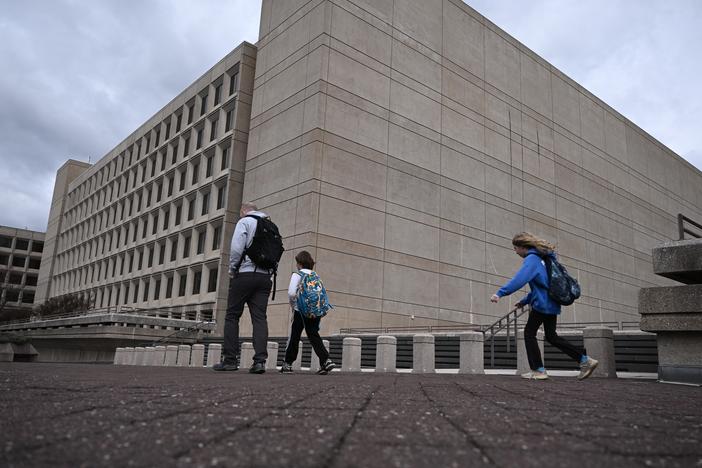 People walk past the U.S. Department of Energy building in Washington, D.C.