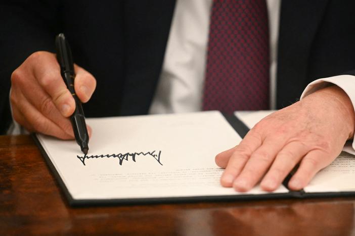 President Trump signs an executive order in the Oval Office of the White House on Jan. 20. Trump has used executive orders to establish multiple national emergencies, which give him access to expanded powers.