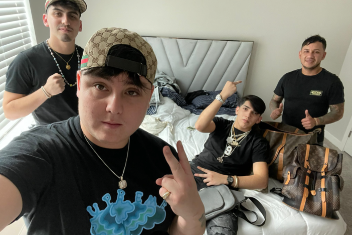 The FBI says this photograph, taken the day after NFL quarterback Joe Burrow's house was burglarized, shows several suspects in the crime with items that were reported stolen, including Burrow's jewelry bearing his jersey number, 9. The agency believes the theft was the work of a South American crime ring.