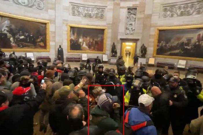 A screenshot showing Glen Simon (highlighted in the red rectangle) entering the U.S. Capitol Rotunda on Jan. 6, 2021. Prosecutors cited this photo in the case against Glen Simon. A coalition of media organizations said Tuesday that video evidence from Simon's case had "disappeared" from a government platform.