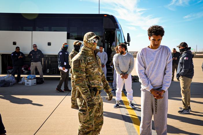 The Department of Homeland Security released photos of migrants as they boarded planes for Guantánamo Bay, Cuba.