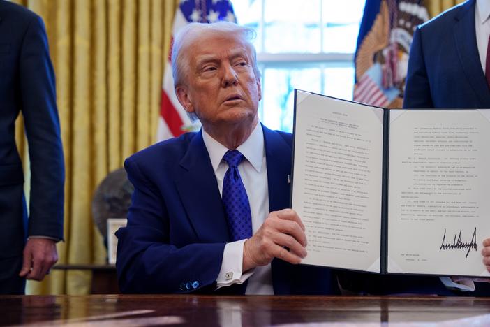 President Donald Trump signs an executive order withholding federal funding from schools and universities that impose a COVID-19 vaccine mandate in the Oval Office on Feb. 14, 2025. Many of Trump's executive actions are facing legal challenges in the courts.