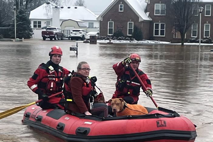 Clarksville Fire Rescue members perform water rescues to evacuate trapped people during flooding on Sunday in Clarksville, Tenn.