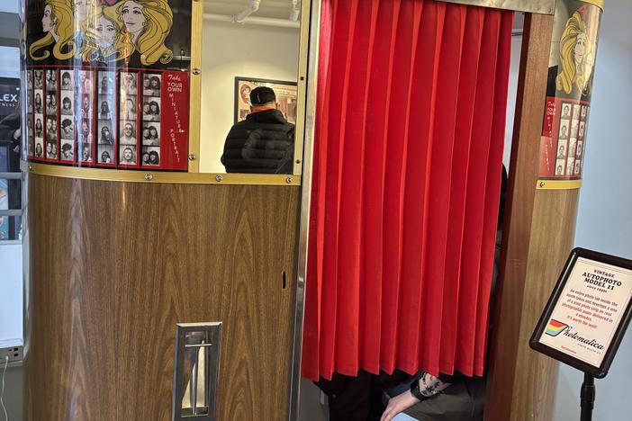 Guests get cozy in a vintage machine at the Photo Booth Museum by Photomatica in San Francisco.