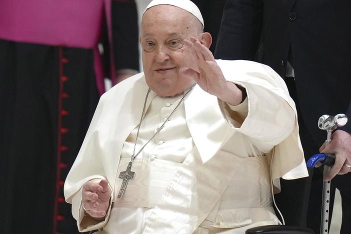 Pope Francis waves as he arrives for his weekly general audience in the Paul VI Hall, at the Vatican, Wednesday, Feb. 12, 2025.