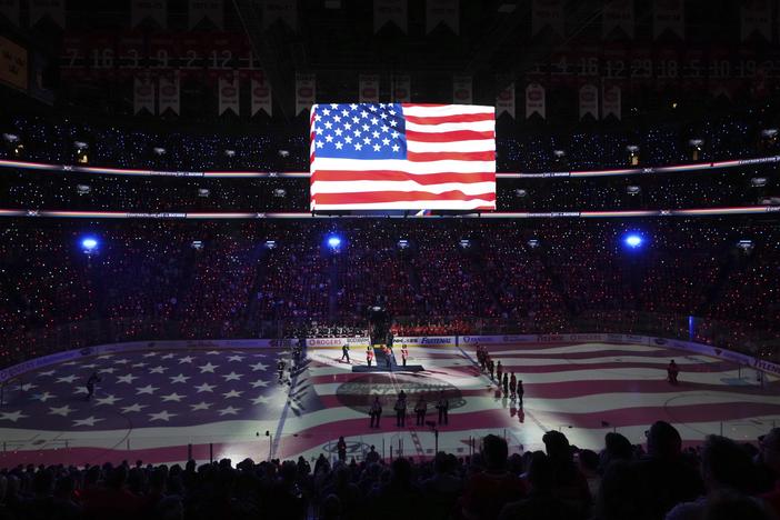 Players and fans stand for the U.S. national anthem prior to the first period of 4 Nations Face-Off hockey game between Canada and the United States in Montreal on Saturday, Feb. 15, 2025.