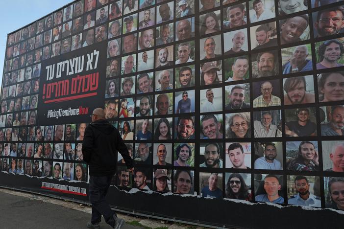 A man walks past a billboard bearing the portraits of Israeli hostages held in the Gaza Strip since the Oct. 7, 2023, attacks by Hamas-led militants, in Jerusalem on Monday, as the country marked the 500th day since their abduction.