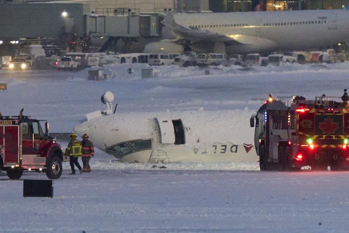 A Delta Air Lines regional jet sits upside-down after crashing upon landing at Toronto Pearson International Airport on Monday.